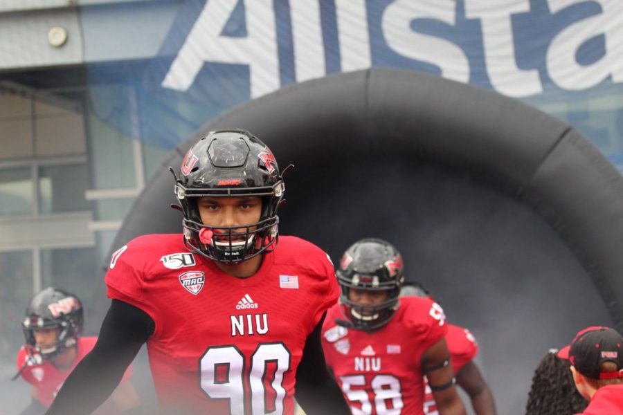 Caleb Wright, redshirt first-year defensive tackle, rushes out of the tunnel Oct. 5 before kick off against Ball State University at Huskie Stadium.