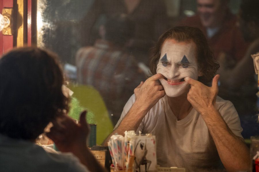 Arthur Fleck, played by Joaquin Phoenix, tries to put on a happy face in Joker.