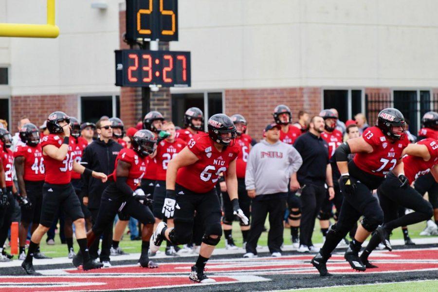 The Huskies run onto the field Oct. 5 at Huskie Stadium before a game against Ball State University.