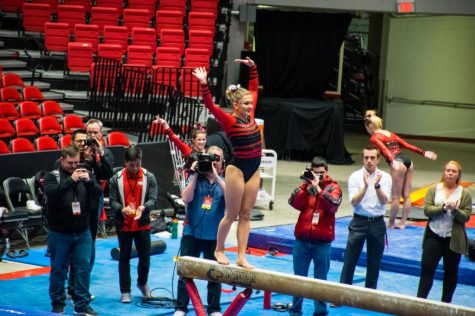 Alumna Anna Martucci performs her routine on the beam March 28 during NIU's the Beauty and the Beast competition at the Convocation Center.