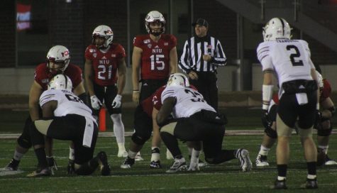 Huskie offense prepares for its next play Tuesday during a home game against Western Michigan University at Huskie Stadium.