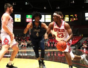 Then-first-year guard Tyler Cochran looks to get the edge on a screen Monday during NIUs 65-48 win against Longwood University at the Convocation Center.