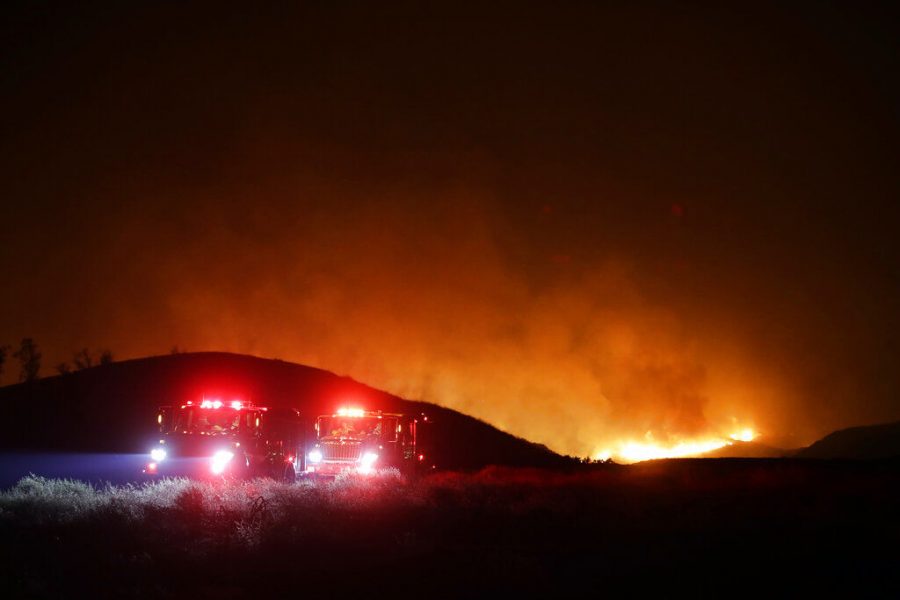 Fire crews stage on a fire road in front of the Maria Fire Thursday, Oct. 31, 2019, in Somis, Calif. (AP Photo/Marcio Jose Sanchez)