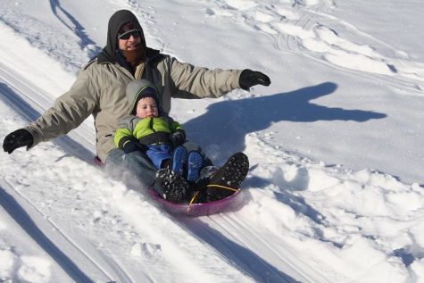 Family enjoys sledding in Hopkins Park in 2019.