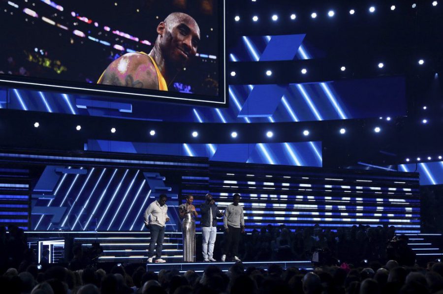 Nathan Morris, from left, Wanya Morris, Shawn Stockman, of Boyz II Men‎, and Alicia Keys, second left, sing a tribute in honor of the late Kobe Bryant, seen on screen, at the 62nd annual Grammy Awards  Sunday in Los Angeles.
