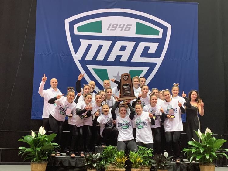 The gymnastics team celebrates after winning the program's first ever Mid-American Conference Championship March 23, 2019, in DeKalb.