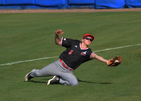Sophomore outfielder Nick Drobushevich makes a sliding catch during NIU's Feb. 15 game against Boston College University in Winter Haven, Florida.