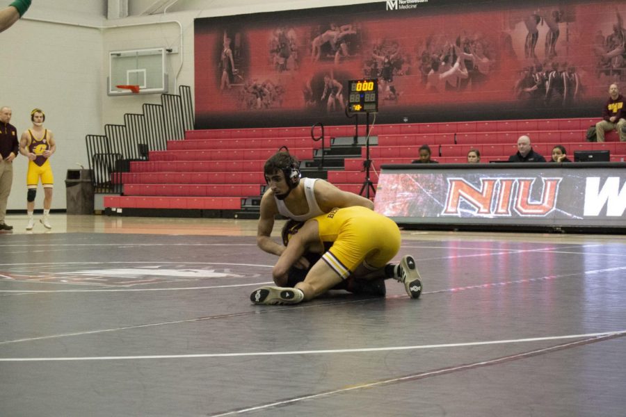 Redshirt first-year Caleb Brooks tangles with a Central Michigan University Chippewa on Jan. 5 at Victor E. Court.