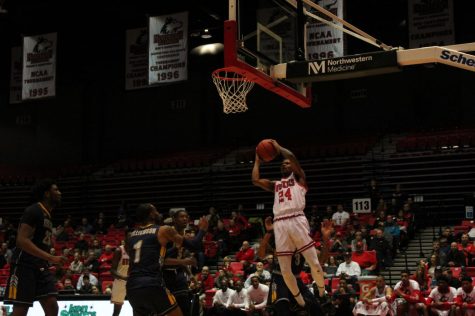 Sophomore Darius Beane (no.24) drives under the basket Feb. 7 during NIU's 57-54 win over Kent State University at the Convocation Center.
