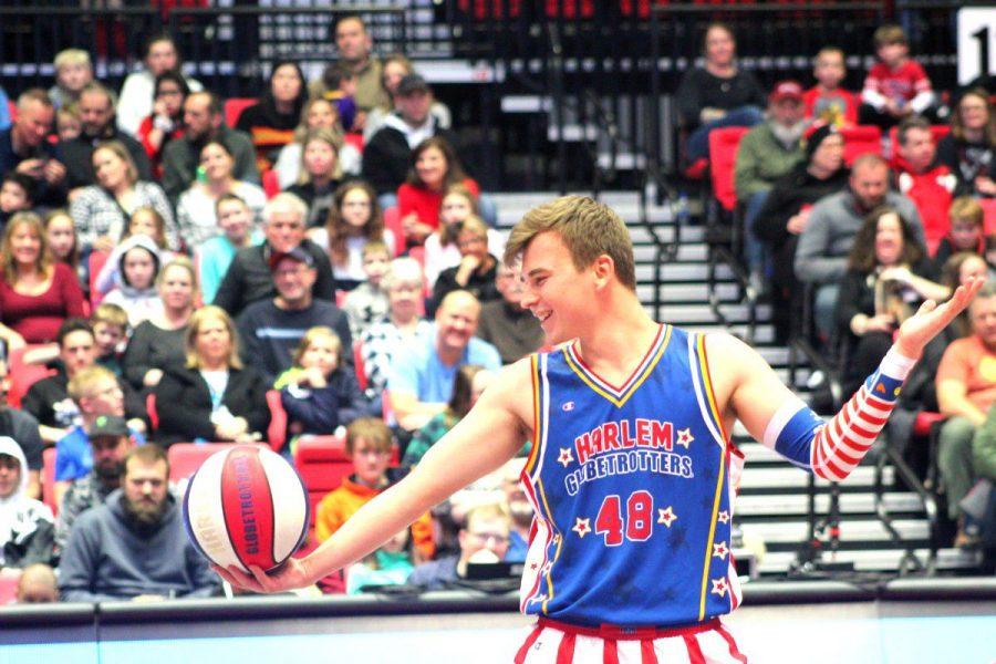 Globetrotter Dazzle Kidoń does tricks with a basketball Thursday during the Harlem Globetrotters game at the Convocation Center.