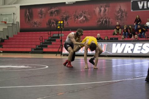 Redshirt sophomore Bryce West (left) grapples with his Chippewa opponent Jan. 5 during NIU's 19-12 win over Central Michigan University at Victor E. Court.