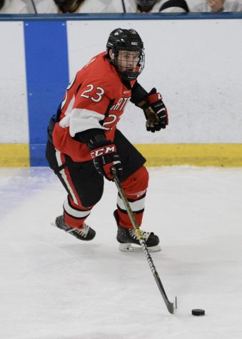 First-year forward Rodahn Evans carries the puck up ice Feb. 14 against Robert Morris University at Edge Ice Arena in Bensenville, Illinois. NIU would go on to lose 10-3.