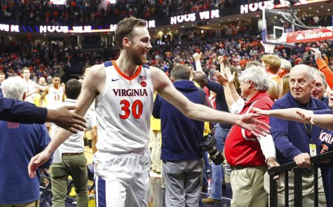 Virginia forward Jay Huff (30) celebrates with fans after defeating Duke in an NCAA college basketball game Saturday, Feb. 29, 2020, in Charlottesville, Va. (AP Photo/Andrew Shurtleff)