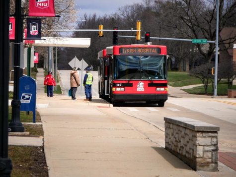 NIU bus driver speaks with a passenger Monday outside the Holmes Student Center.