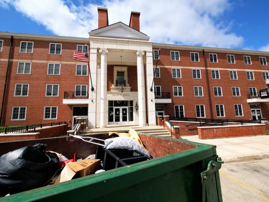 A dumpster sits outside Gilbert Hall Monday filled with trash from students moving out early because of the COVID-19 pandemic.