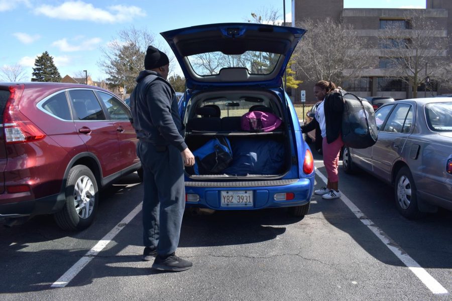 Jolan Lacy-Jones (right), sophomore performing arts major, loads her belongings into her father Kevin Jones trunk in the visitors lot. Shes relatively sad, she said, but ready to go home and chill.
