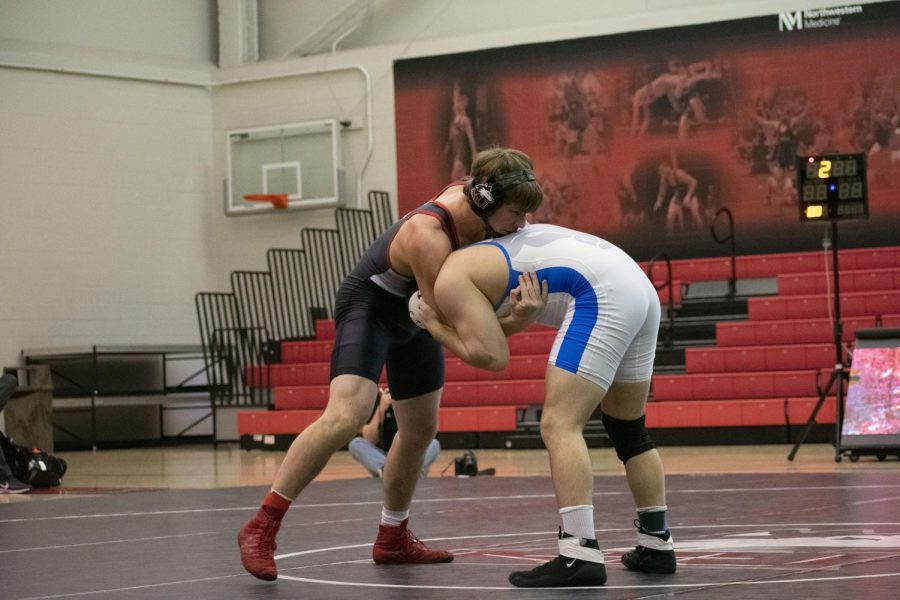 Then-redshirt sophomore Brit Wilson grapples Feb. 14 with his Bull opponent during NIUs 19-16 win at Victor E. Court.