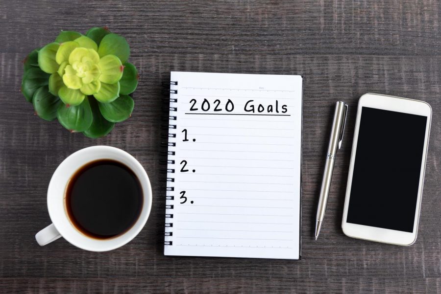 A desk with a 2020 Goals checklist