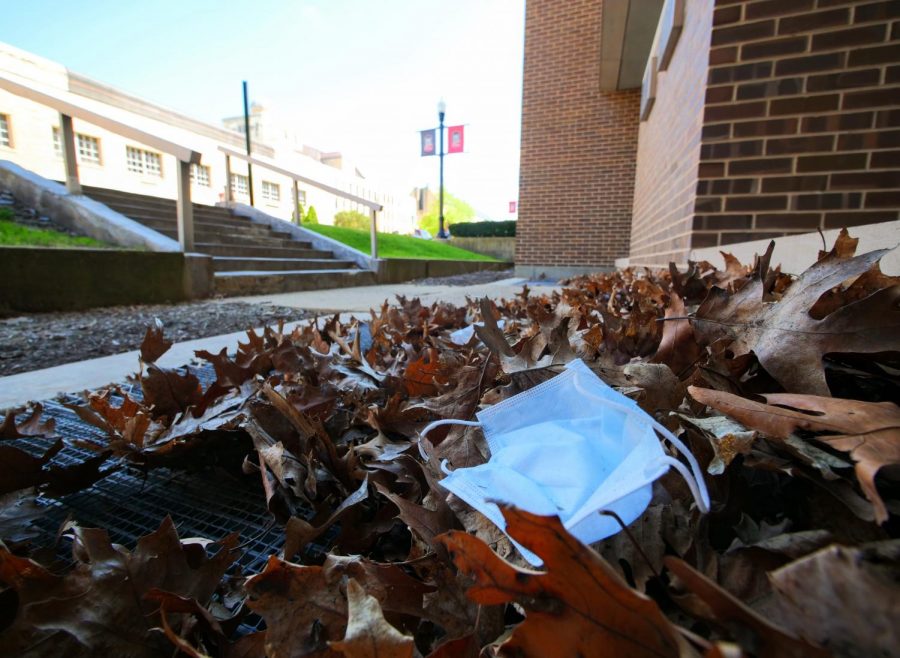 An abandoned face mask lays in a pile of leaves outside NIUs Founders Memorial Library on Tuesday, May 12th.