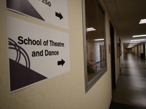 a sign points to the School of Theatre and Dance