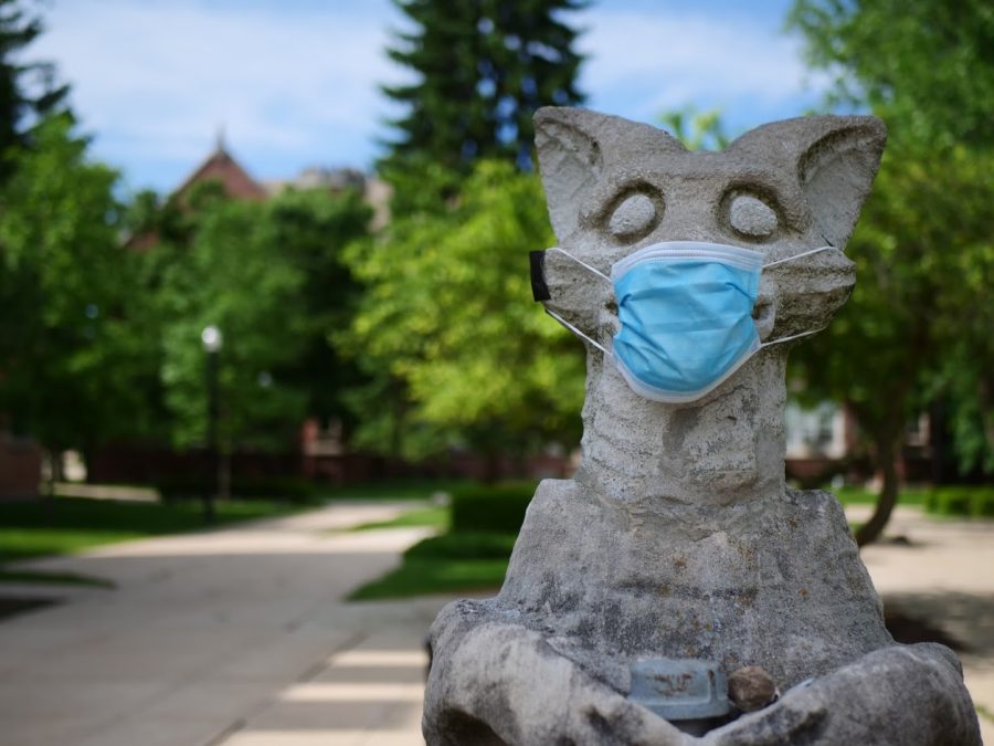 A mask is taped to NIU's Olive Goyle statue next to Altgeld Hall June 3.