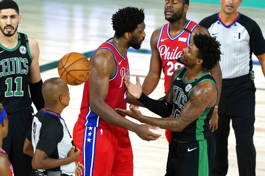 Philadelphia 76ers Joel Embiid, left, and Boston Celtics Marcus Smart, right, exchange words during the second half of an NBA basketball first round playoff game Monday, Aug. 17, 2020, in Lake Buena Vista, Fla. 