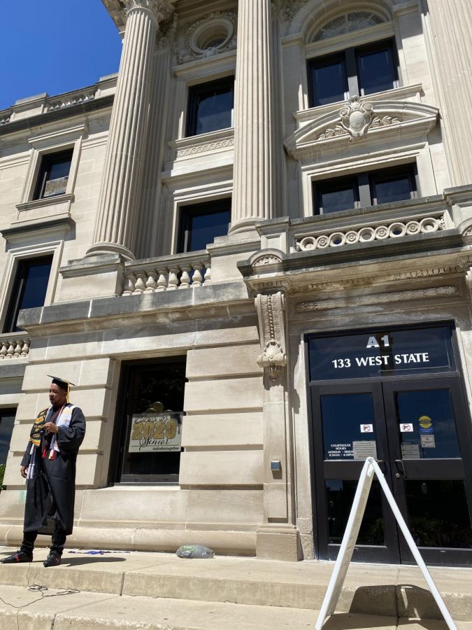 Advocacy and public communication major Roderic Moyer stands outside the DeKalb County Courthouse, 133 W. State St., Sycamore, wearing his cap and gown after instructor Michele Duffy’s request for an order of protection against him was denied Tuesday.