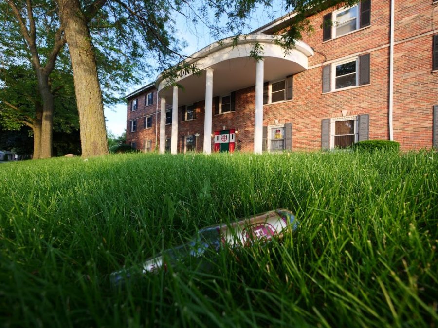 An empty beer bottle lies littered on the front lawn of a fraternity house on West Hillcrest Drive in DeKalb