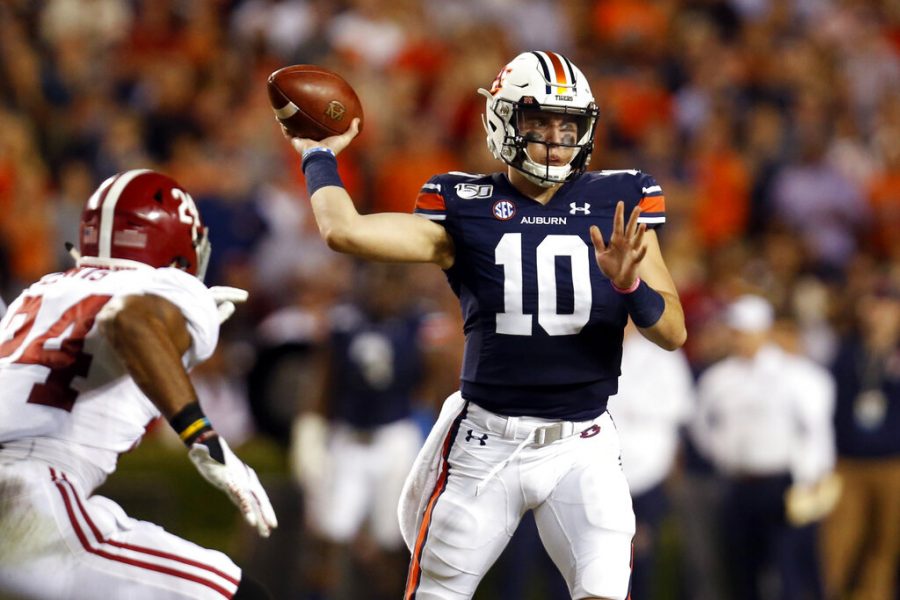 In this Nov. 30, 2019, file photo, Auburn quarterback Bo Nix (10) throws a pass as Alabama linebacker Terrell Lewis (24) pressures during the second half of an NCAA college football game in Auburn, Ala. Auburn, which returns Nix, is trying to again break through in the competitive SEC Western Division. (AP Photo/Butch Dill, File)