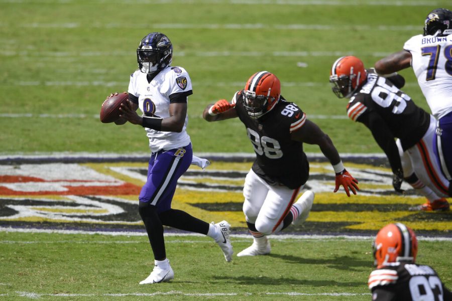 Baltimore Ravens quarterback Lamar Jackson (8) looks to pass as he is pursued by Cleveland Browns defensive tackle Sheldon Richardson (98), during the first half of an NFL football game, Sunday, Sept. 13, 2020, in Baltimore, MD. (AP Photo/Nick Wass)