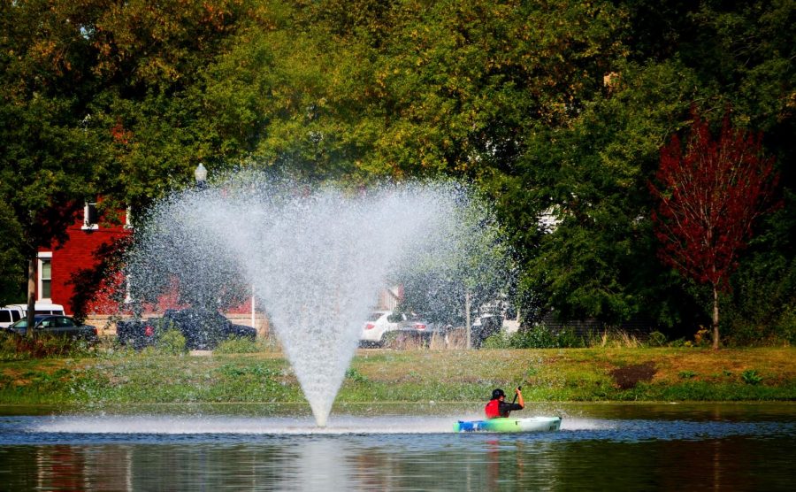 Student kayaks Monday past a fountain in the Lagoon.