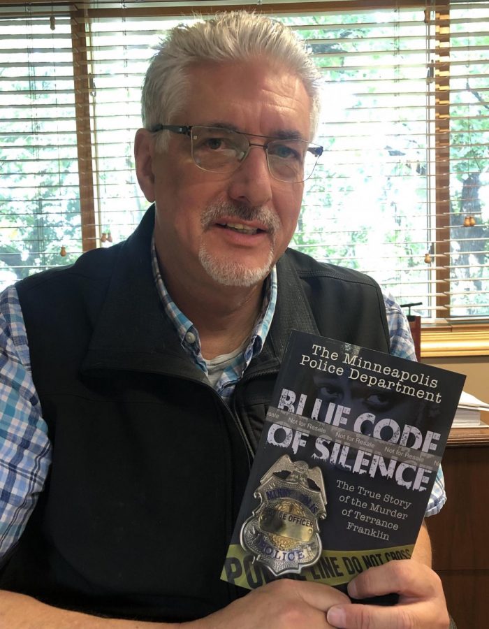 Author Mike Padden holding his book “The Minneapolis Police Department: Blue Code of Silence”