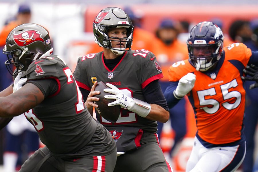 Tampa Bay Buccaneers quarterback Tom Brady, center, looks to throw a pass during the first half of an NFL football game against the Denver Broncos, Sunday, Sept. 27, 2020, in Denver.