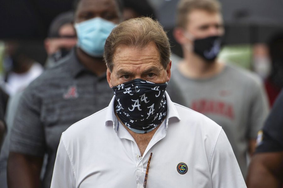 FILE - In this Aug. 31, 2020, file photo, Alabama head football coach Nick Saban leads his team as they march on campus, supporting the Black Lives Matter movement, in Tuscaloosa, Ala. The mid-week news that Alabama coach Nick Saban tested positive for COVID-19 added a challenging backdrop for the season’s first Top 5 matchup. Saban figures to be communicating his marching orders and input from home while offensive coordinator Steve Sarkisian is manning the show within the football building. (AP Photo/Vasha Hunt, File)
