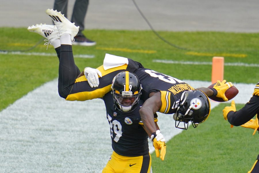 Pittsburgh Steelers wide receiver JuJu Smith-Schuster (19) spins wide receiver James Washington (13) on his shoulders after Washington caught a touchdown pass against the Cleveland Browns during the first half of an NFL football game, Sunday, Oct. 18, 2020, in Pittsburgh. 