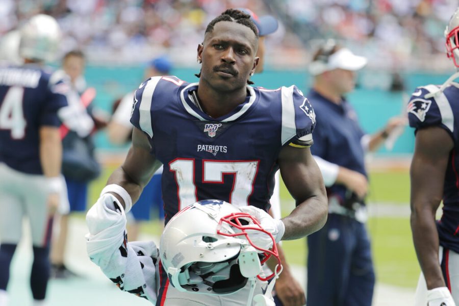 FILE - In this Sunday, Sept. 15, 2019, file photo, New England Patriots wide receiver Antonio Brown stands on the sidelines during the first half at an NFL football game against the Miami Dolphins in Miami Gardens, Fla. Brown has agreed to return to the NFL with the Tampa Bay Buccaneers on a one-year deal, according to a person with knowledge of the move. The person spoke to The Associated Press on condition of anonymity Saturday, Oct. 24, 2020 because the contract had not been completed.