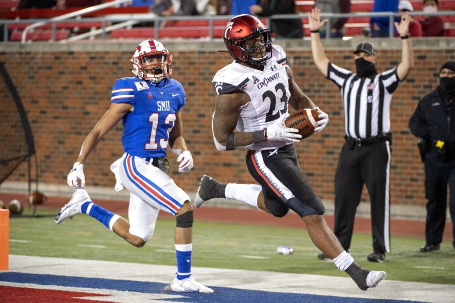 Cincinnati running back Gerrid Doaks (23) cruises into the end zone in front of SMU safety Roderick Roberson, Jr. (13) on a touchdown run during the second half of an NCAA college football game Saturday, Oct. 24, 2020, in Dallas. Cincinnati won 42-13.