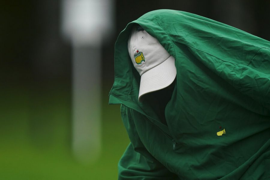 Joe Mulholland puts on a rain jacket during a practice round at the Masters golf tournament Wednesday, Nov. 11, 2020, in Augusta, Ga. 