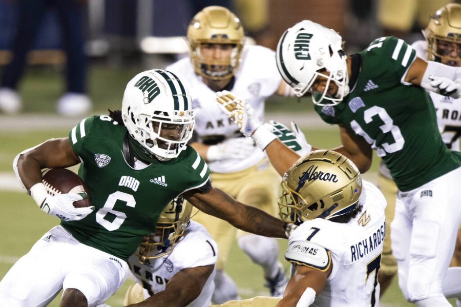 FILE — In this Nov. 10, 2020 file photo, Ohio Bobcats wide receiver Isiah Cox (6) runs the ball past Akron Zips linebacker Julian Richardson (7) during an NCAA football game in Athens, Ohio. An NCAA official voiced concern, Thursday, Nov. 12, 2020, over sports betting on the performance of individual student athletes, and suggested that gambling regulators consider restrictions on such wagers to protect the integrity of the games. 