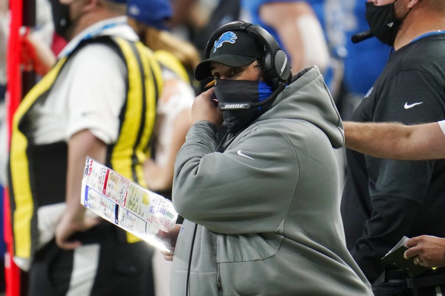 Detroit Lions head coach Matt Patricia adjusts his face mask during the second half of an NFL football game against the Houston Texans, Thursday, Nov. 26, 2020, in Detroit.