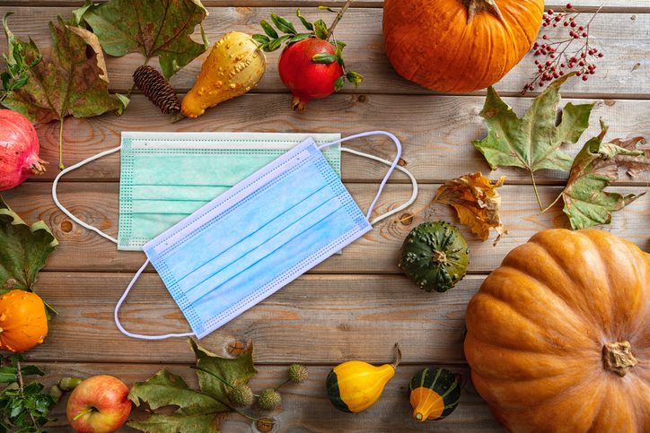 Thanksgiving 2020, coronavirus days, Protective face mask and thanksgiving flatlay on wooden background. COVID 19 spread prevention measure