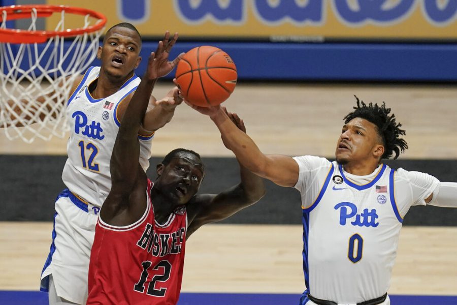 Pittsburghs Ithiel Horton (0) gets a rebound in front of Northern Illinois Zool Kueth, front left, and Pittsburghs Abdoul Karim Coulibaly during the first half of an NCAA college basketball game Saturday, Dec. 5, 2020, in Pittsburgh. (AP Photo/Keith Srakocic)