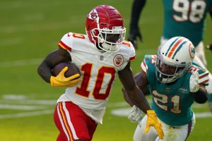 Kansas City Chiefs wide receiver Tyreek Hill (10) runs for a touchdown as Miami Dolphins free safety Eric Rowe (21) attempt to tackle, during the first half of an NFL football game, Sunday, Dec. 13, 2020, in Miami Gardens, Fla.