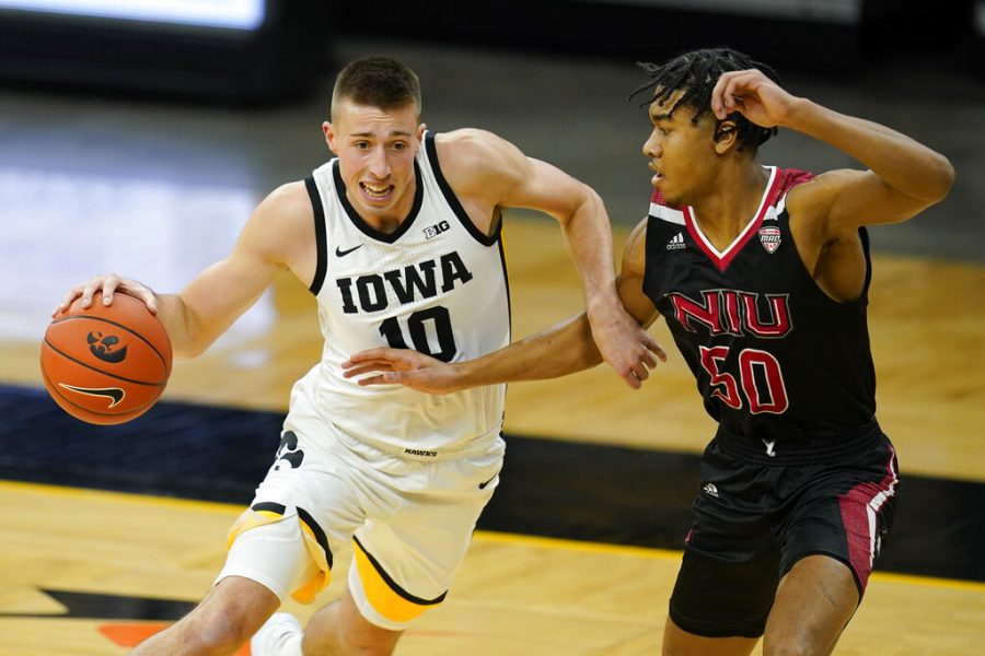 Iowa guard Joe Wieskamp drives past Northern Illinois guard Anthony Crump, right, during the first half of an NCAA college basketball game, Sunday, Dec. 13, 2020, in Iowa City, Iowa.