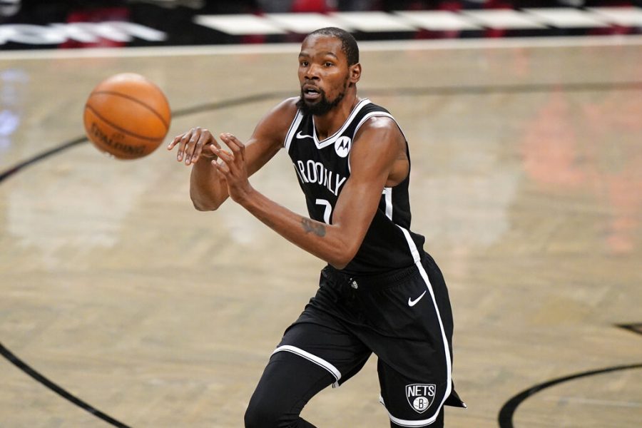 Brooklyn Nets forward Kevin Durant (7) passes during the first half of a preseason NBA basketball game against the Washington Wizards, Sunday, Dec. 13, 2020, in New York.