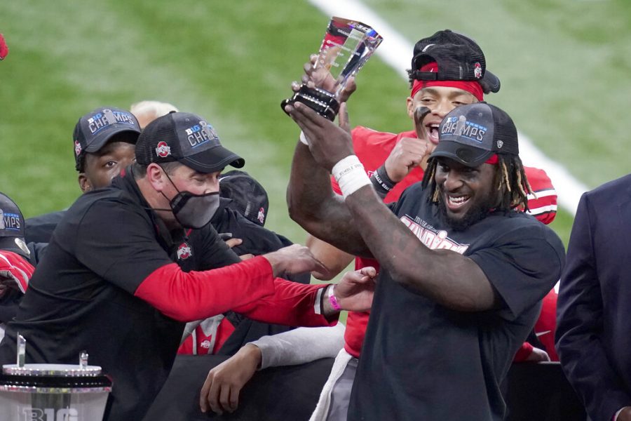 Ohio State running back Trey Sermon, right, is congratulated by head coach Ryan Day, left, after being named most valuable player following the Big Ten championship NCAA college football game, Saturday, Dec. 19, 2020, in Indianapolis. Ohio State defeated Northwestern 22-10.