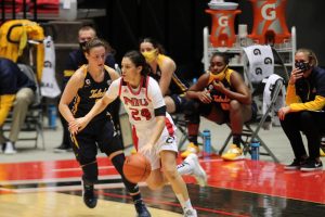 Redshirt senior guard Paulina Castro (right) drives past sophomore guard Sophia Ward Dec. 10, during NIU's 82-79 loss to the University of Toledo Rockets at the NIU Convocation Center in DeKalb.