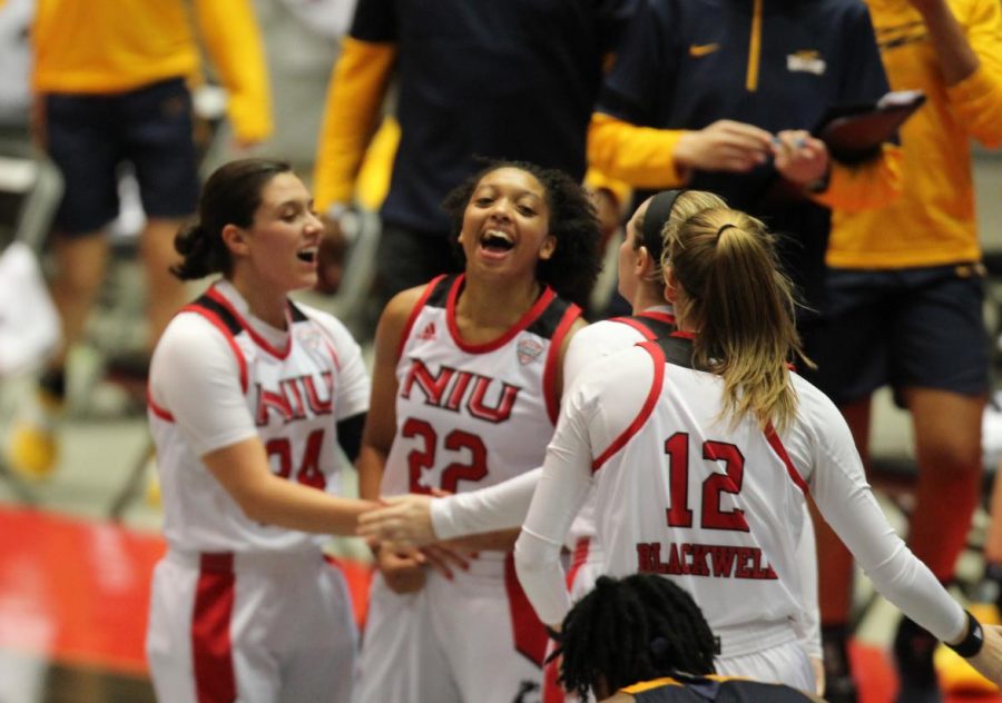 Redshirt junior guard Janae Possion (center) celebrates with redshirt senior guard Paulina Castro (left), sophomore guard Chelby Koker (second from right) and senior forward Riley Blackwell (right) Dec. 10, after making back-to-back 3-pointers during NIUs 82-79 loss to the University of Toledo at the NIU Convocation Center in DeKalb.