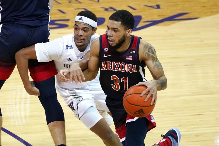 Arizona's Terrell Brown Jr. (31) drives past Washington's Quade Green in the second half of an NCAA college basketball game Thursday, Dec. 31, 2020, in Seattle.