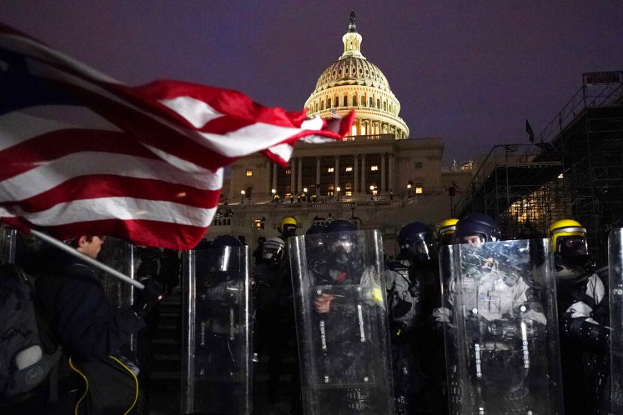 Police stand Wednesday outside the Capitol after a day of protesters rioting.